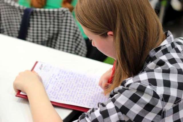 person writing in notebook